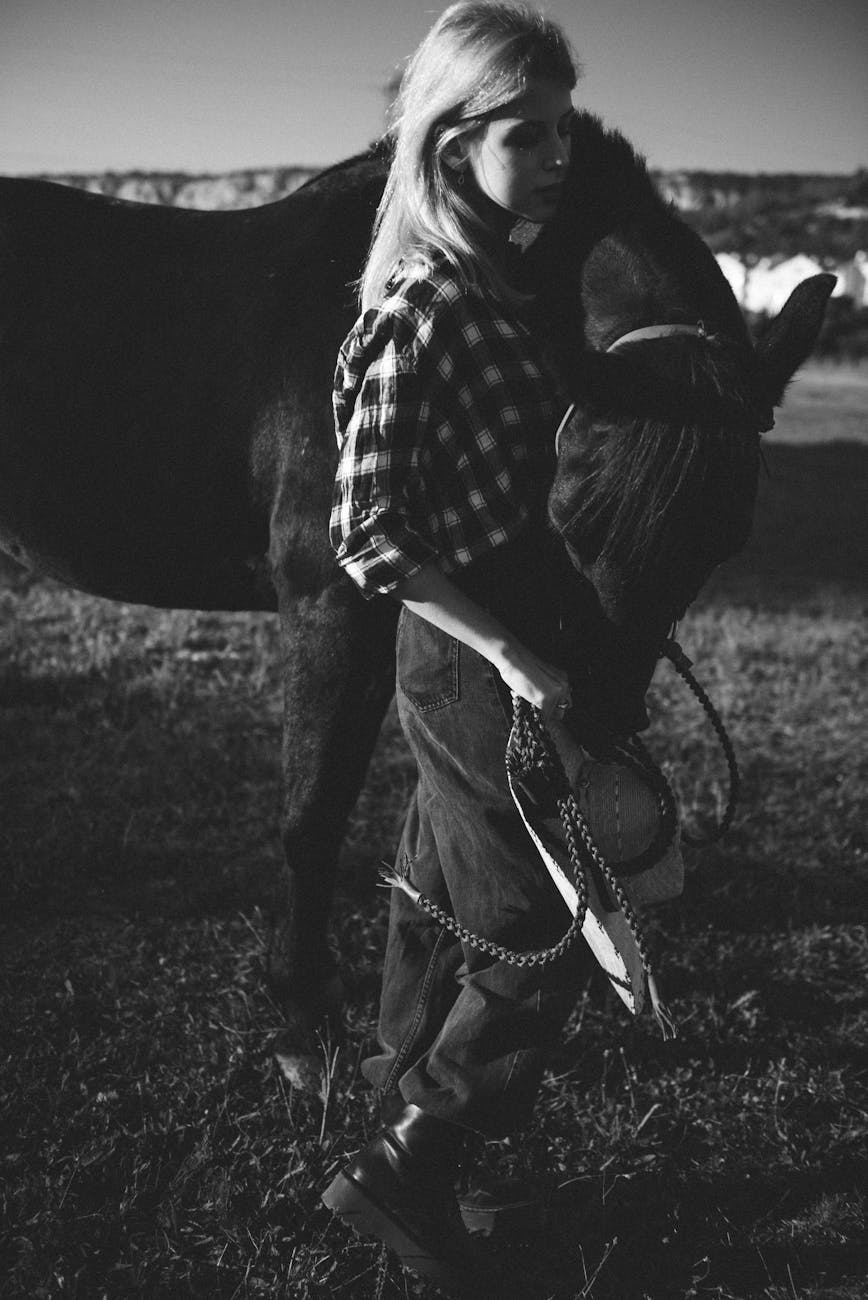 a woman walking side by side with a horse